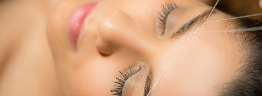 Close-up of eyebrow threading